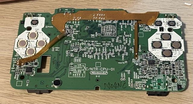 A screenshot of the Nintendo DS motherboard. The side shown is the front, showing the capture card flex PCB that's installed onto the motherboard.